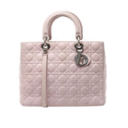 Pale pink Christian Dior Lady Dior Large handbag with Cannage quilting, rounded top handles, a matching shoulder strap and silver-tone Dior charms.