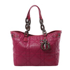 Purple Christian Dior Cannage tote with leather trim, dark wooden links on the shoulder straps, silver-tone fittings and hanging Dior letter charms.