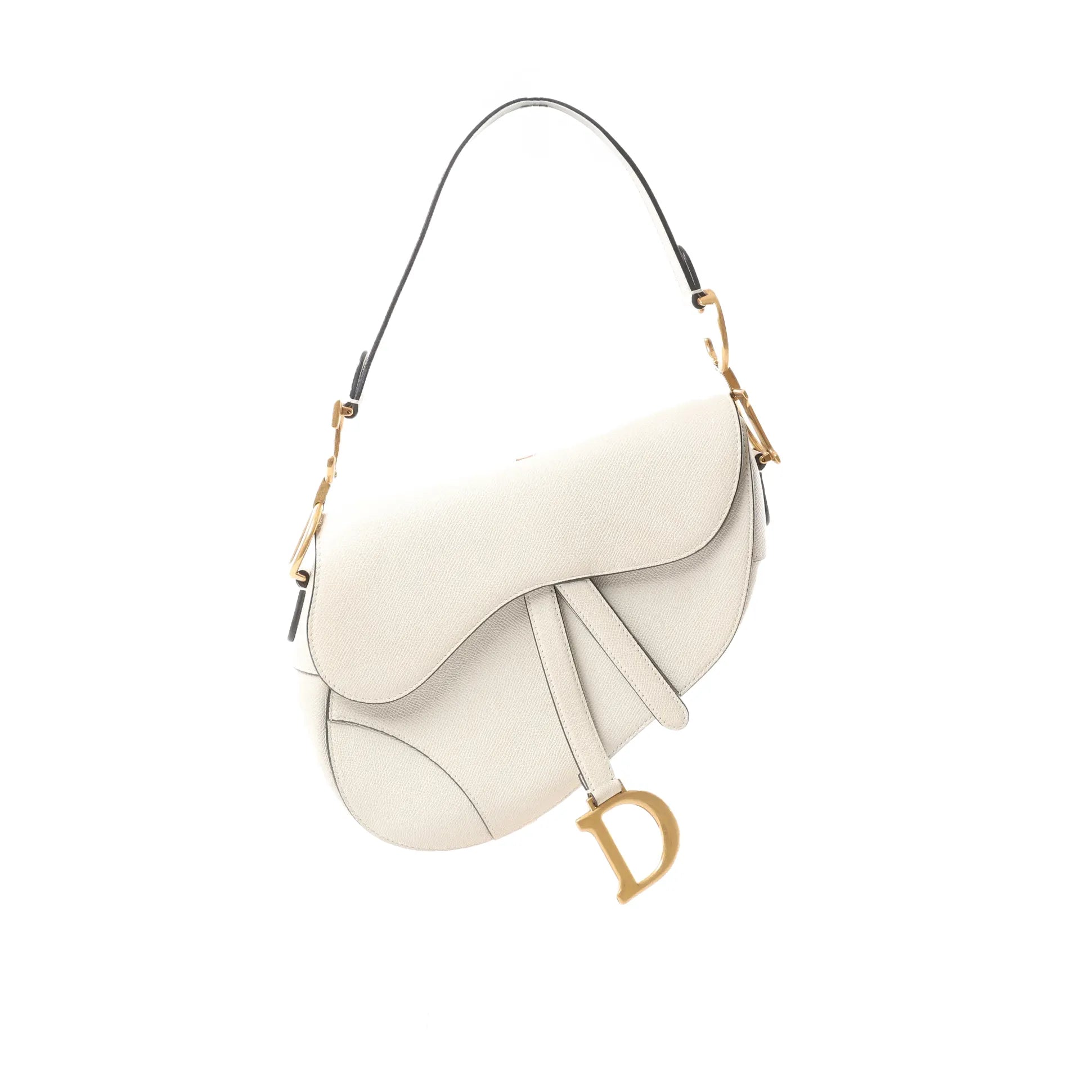White Dior Saddle shoulder bag with curved flap, adjustable strap, and large gold-tone D charm hanging at the side