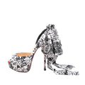 Christian Louboutin ERSEY VAMP 150 satin heels in size 37 EU, showcasing a black-and-white graffiti-inspired Jwall graphic print, peep toe design, platform sole, high stiletto heel, and oversized bow detail at the heel.