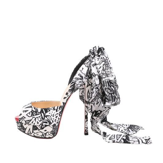 Christian Louboutin ERSEY VAMP 150 satin heels in size 37 EU, showcasing a black-and-white graffiti-inspired Jwall graphic print, peep toe design, platform sole, high stiletto heel, and oversized bow detail at the heel.