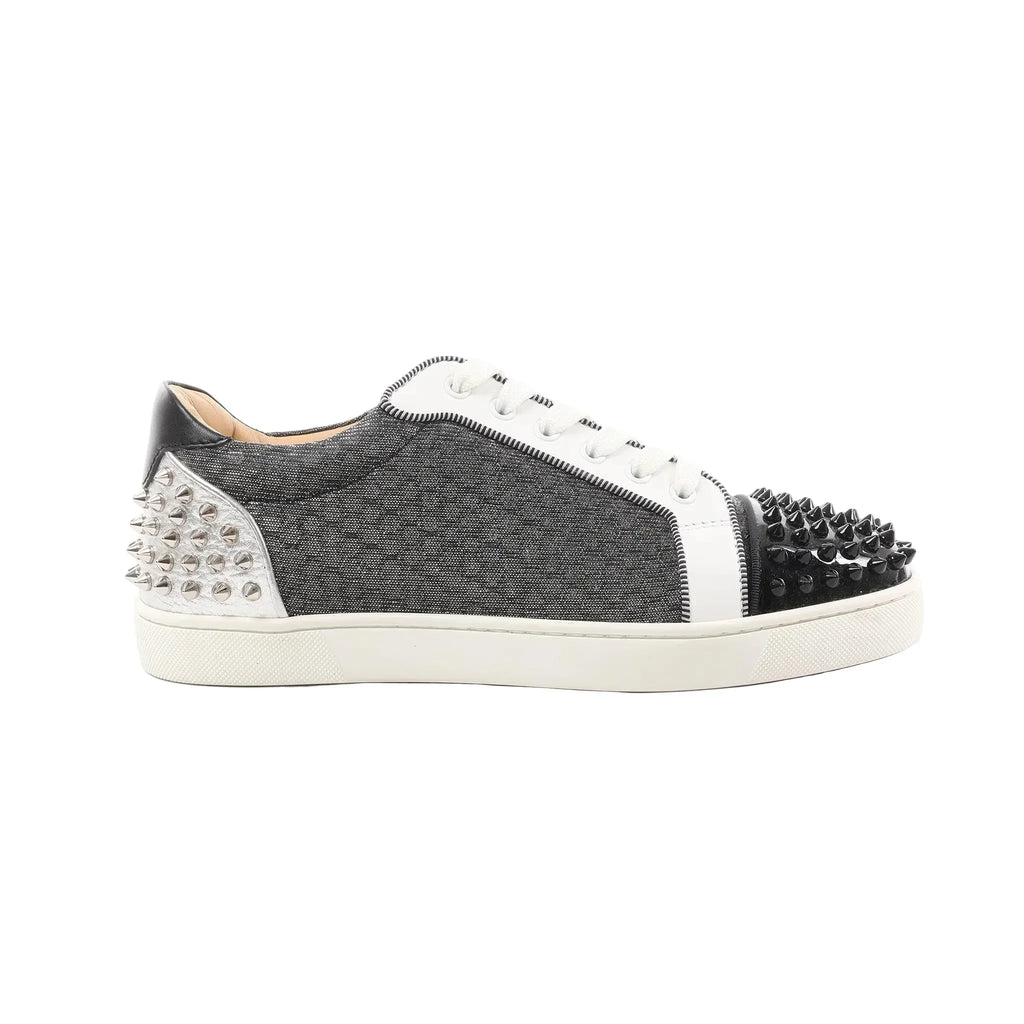 Gray Christian Louboutin low-top sneakers with white laces, black spiked toe cap, white side panels, and silver studded heel, size 41 EU.