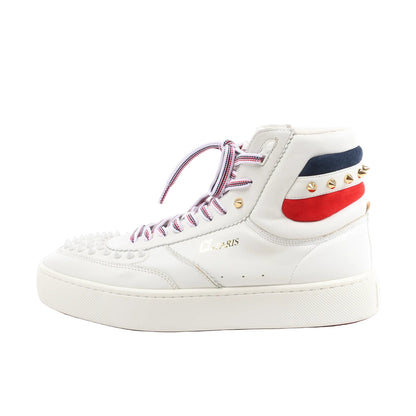 Side view of a white Christian Louboutin leather high-top sneaker in size 42.5 EU, featuring spiked toe detailing, red-white-blue laces, tricolor suede heel panels, and gold-tone studs on a white rubber sole.