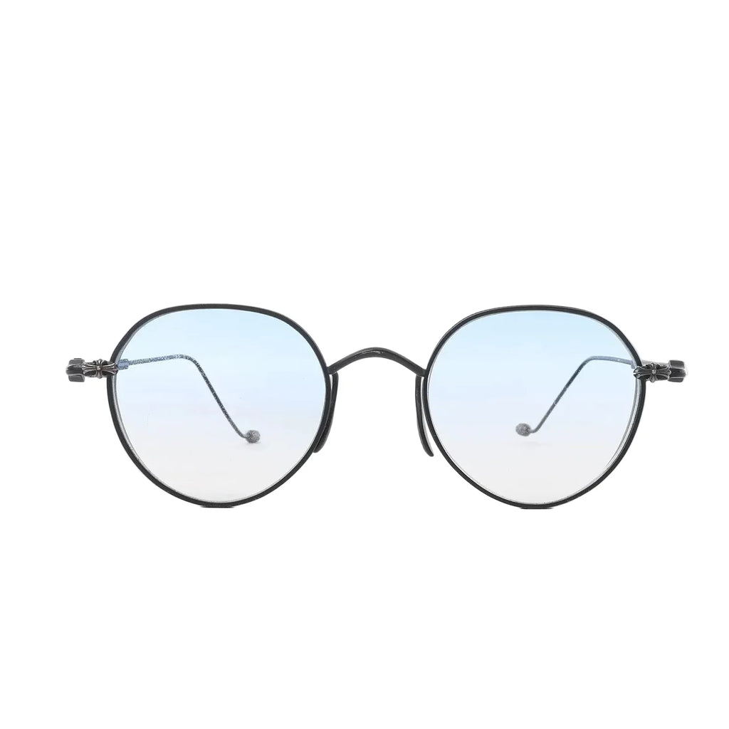 Chrome Hearts round sunglasses with black metal frames, light blue gradient lenses, and cross-style hinge accents on a white background.