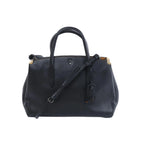 Front view of a black Coach 1941 Cooper Carryall leather handbag with dual top handles, shoulder strap, metal corner accents and a hanging leather tag.