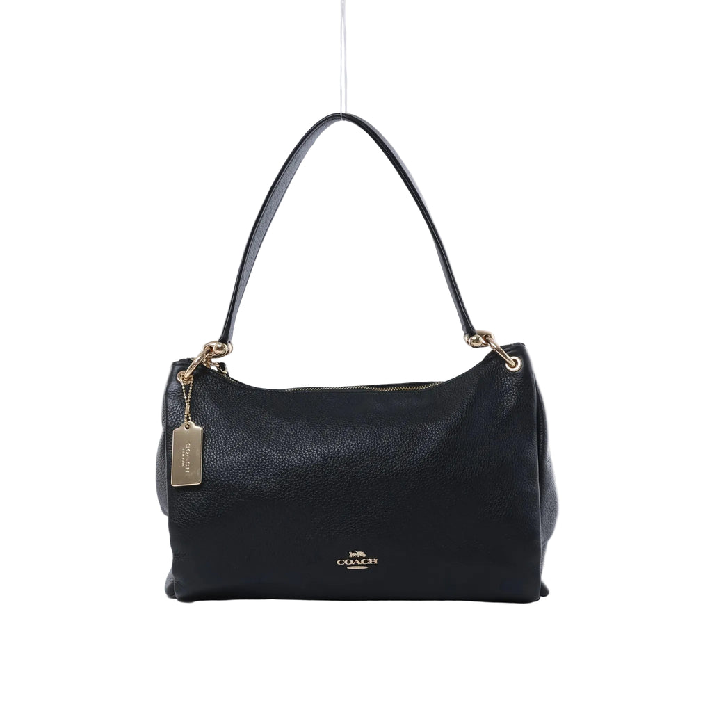 Front view of a black Coach Mia pebbled leather shoulder bag with a single strap, gold-tone hardware, zip top and logo hangtag.