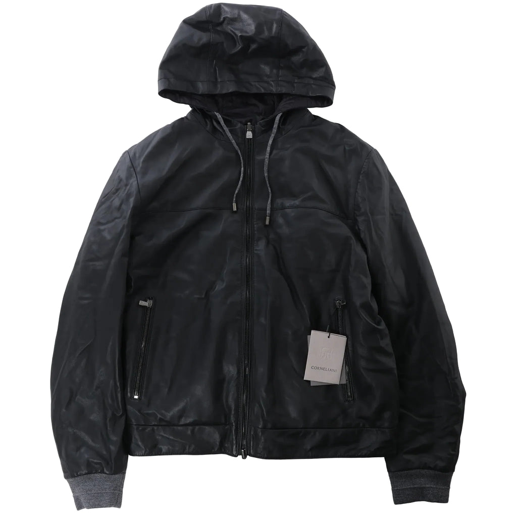 Corneliani reversible black leather hooded jacket with full-zip front, attached hood, zip pockets, ribbed knit cuffs and hem, laid flat on a white background.