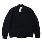 Corneliani O.Wear navy blue bomber jacket with full zip-front closure, ribbed collar, cuffs and hem, and two large flap front pockets, laid flat on a white background.