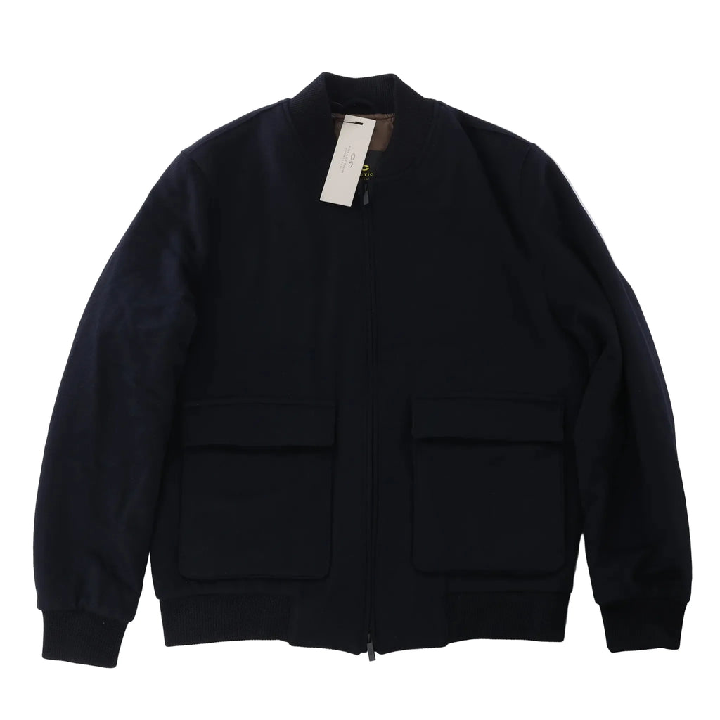 Corneliani O.Wear navy blue bomber jacket with full zip-front closure, ribbed collar, cuffs and hem, and two large flap front pockets, laid flat on a white background.