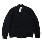 Corneliani O.Wear navy blue bomber jacket with full zip-front closure, ribbed collar, cuffs and hem, and two large flap front pockets, laid flat on a white background.