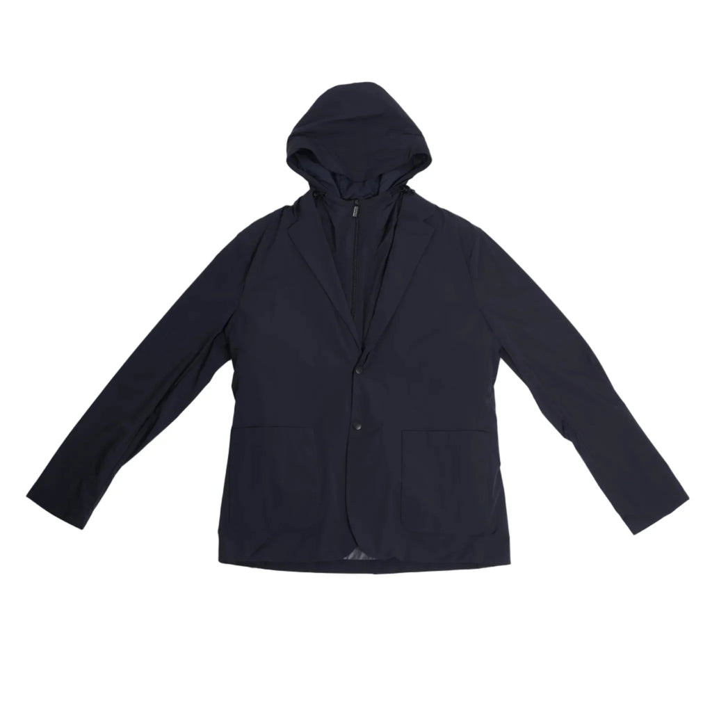 Corneliani CC Collection navy blue jacket in Size 50 IT, featuring a tailored blazer silhouette with a built-in zip-up hooded vest, laid flat on a light background to show full front view.
