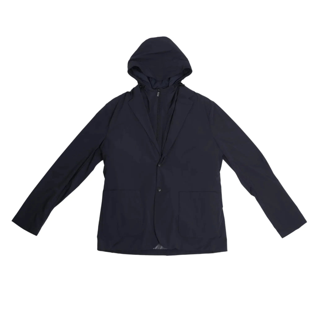 Corneliani CC Collection navy blue jacket in Size 50 IT, featuring a tailored blazer silhouette with a built-in zip-up hooded vest, laid flat on a light background to show full front view.