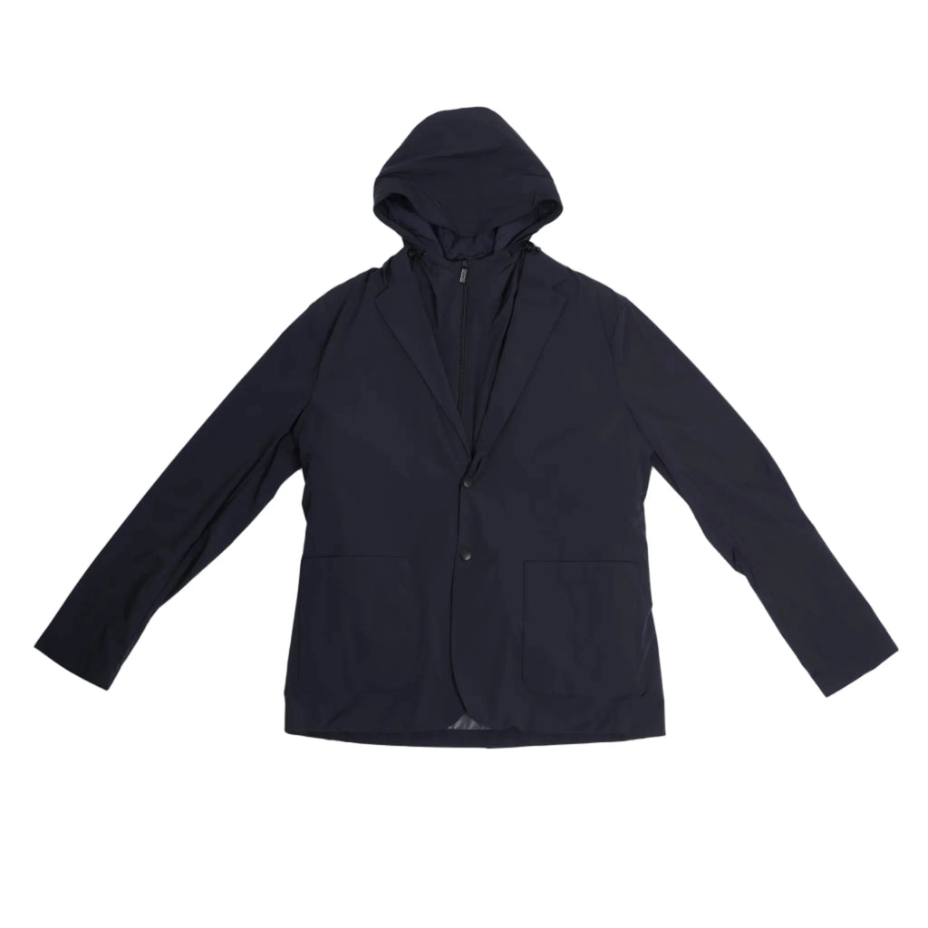 Corneliani CC Collection navy blue jacket in Size 50 IT, featuring a tailored blazer silhouette with a built-in zip-up hooded vest, laid flat on a light background to show full front view.