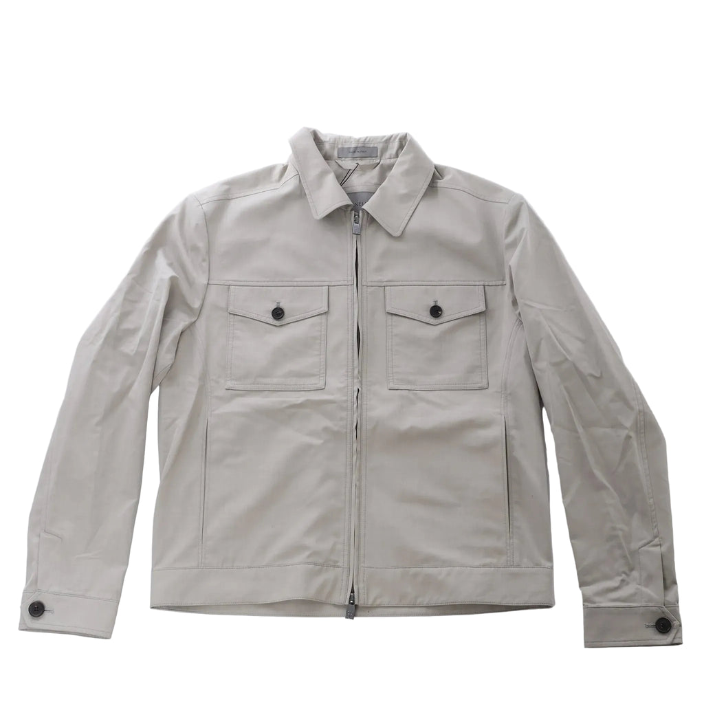 Greenish gray Corneliani jacket with pointed collar, front zip closure, two buttoned flap chest pockets and long sleeves.