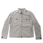 Greenish gray Corneliani jacket with pointed collar, front zip closure, two buttoned flap chest pockets and long sleeves.