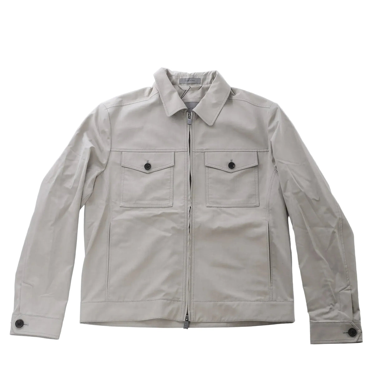 Greenish gray Corneliani jacket with pointed collar, front zip closure, two buttoned flap chest pockets and long sleeves.