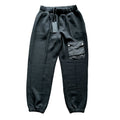 CoSTUME NATIONAL black jogger trousers with an elastic drawstring waistband, side pockets, utility cargo pocket with logo detail and elastic cuffs, laid flat on a white background.