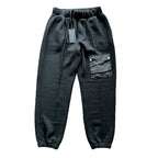 CoSTUME NATIONAL black jogger trousers with an elastic drawstring waistband, side pockets, utility cargo pocket with logo detail and elastic cuffs, laid flat on a white background.