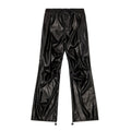 DIESEL oversized cargo trousers in black coated fabric with a glossy leather-look finish, elastic waistband, seam detailing, and adjustable drawstring hems, laid flat against a white background, Size 48 IT.