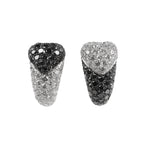 De Grisogono heart-shaped earrings in white gold, featuring a striking combination of white and black pave-set diamonds in an asymmetrical design, displayed against a white background.