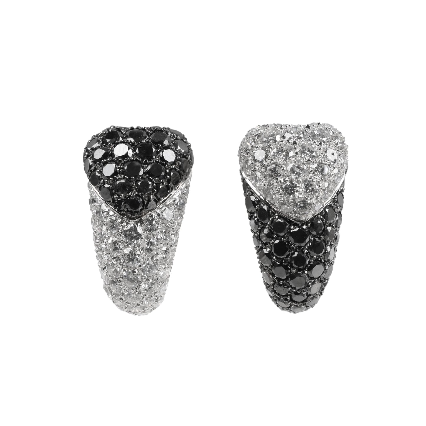 De Grisogono heart-shaped earrings in white gold, featuring a striking combination of white and black pave-set diamonds in an asymmetrical design, displayed against a white background.