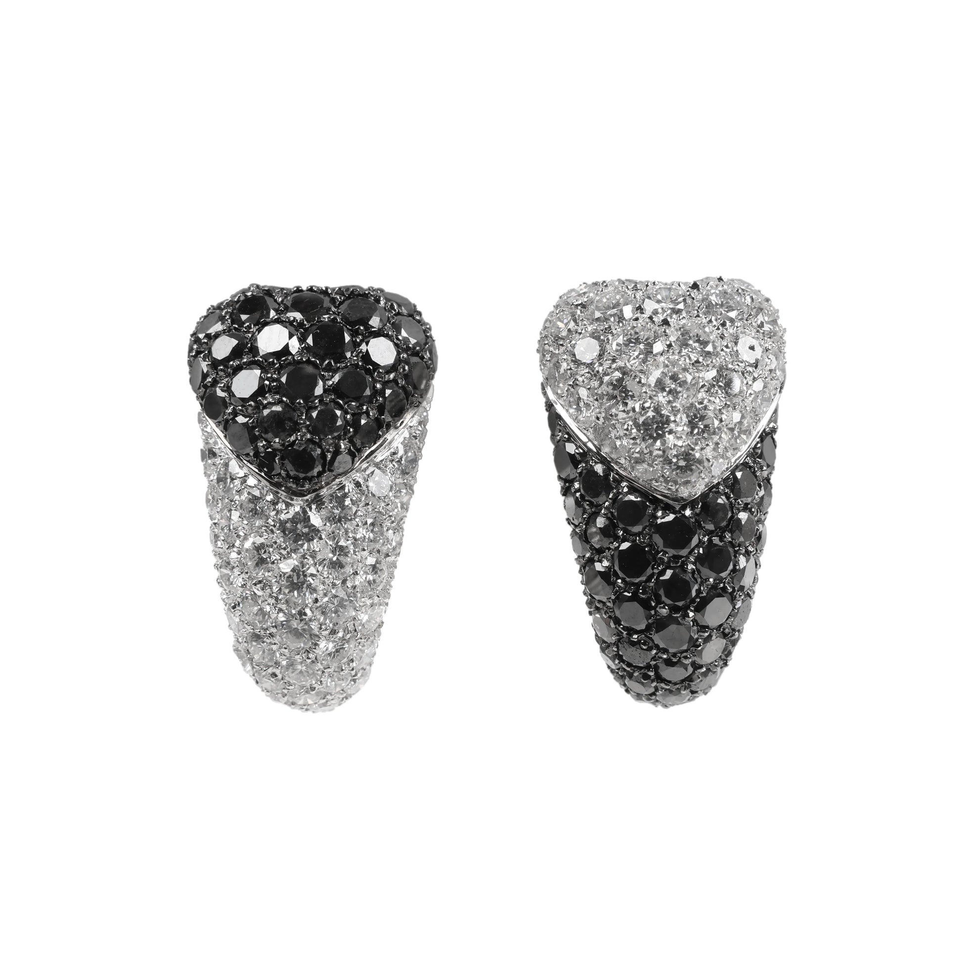 De Grisogono heart-shaped earrings in white gold, featuring a striking combination of white and black pave-set diamonds in an asymmetrical design, displayed against a white background.