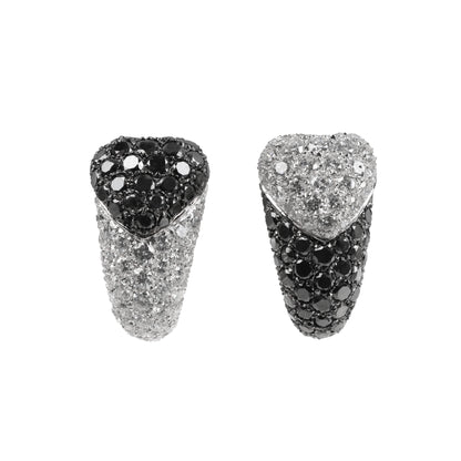De Grisogono heart-shaped earrings in white gold, featuring a striking combination of white and black pave-set diamonds in an asymmetrical design, displayed against a white background.
