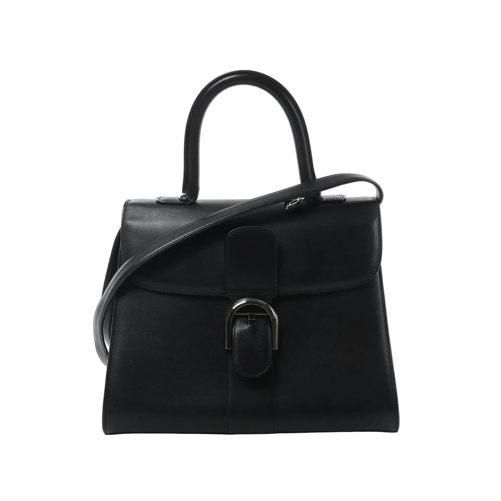 Front view of Delvaux Brillant MM handbag in black leather with top handle, shoulder strap, flap closure, and silver-tone horseshoe buckle hardware.