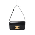 Black Celine Claude leather shoulder bag with a front flap, gold-tone Triomphe clasp and adjustable leather shoulder strap.