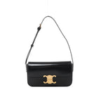 Black Celine Claude leather shoulder bag with a front flap, gold-tone Triomphe clasp and adjustable leather shoulder strap.