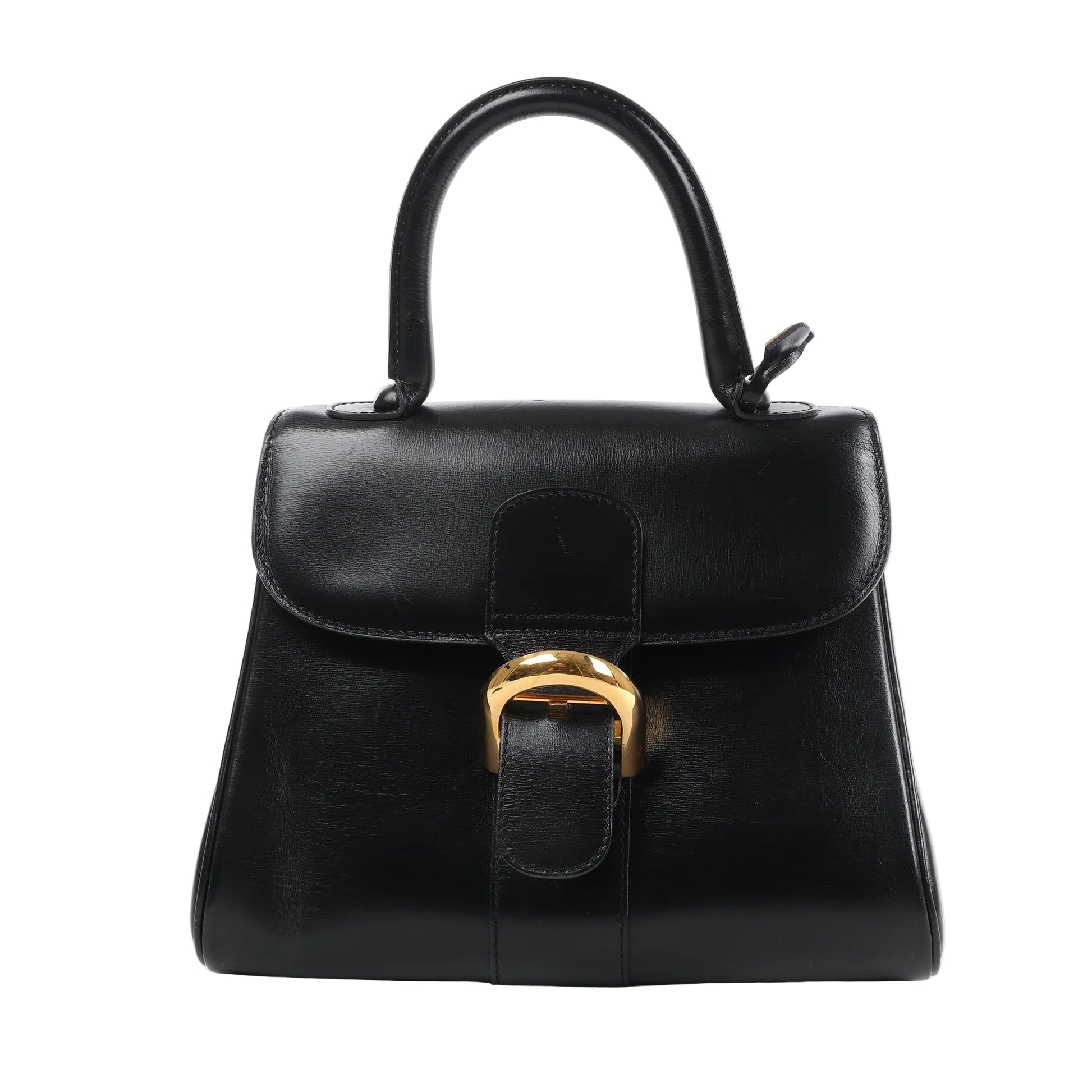 Front-facing Delvaux Brillant PM Handbag in smooth black leather, showcasing a structured silhouette with a curved top flap, top handle, and signature gold-tone buckle closure, set against a white background.