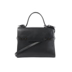 Delvaux Tempête GM black leather top-handle bag with structured flap front, tonal hardware details, and detachable shoulder strap on a white background.