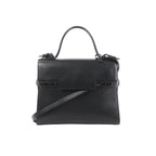 Delvaux Tempête GM black leather top-handle bag with structured flap front, tonal hardware details, and detachable shoulder strap on a white background.