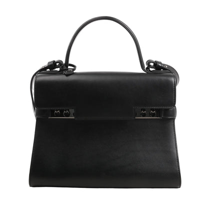 Delvaux Tempête MM 2Way handbag in black smooth leather featuring a structured silhouette, top handle, detachable shoulder strap, and signature studded metal bar closure.