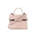 Front view of Delvaux Tempête MM handbag in pale pink leather with top handle, flap front, detachable shoulder strap, and metal side hardware details.