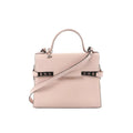 Front view of Delvaux Tempête MM handbag in pale pink leather with top handle, flap front, detachable shoulder strap, and metal side hardware details.