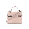 Front view of Delvaux Tempête MM handbag in pale pink leather with top handle, flap front, detachable shoulder strap, and metal side hardware details.