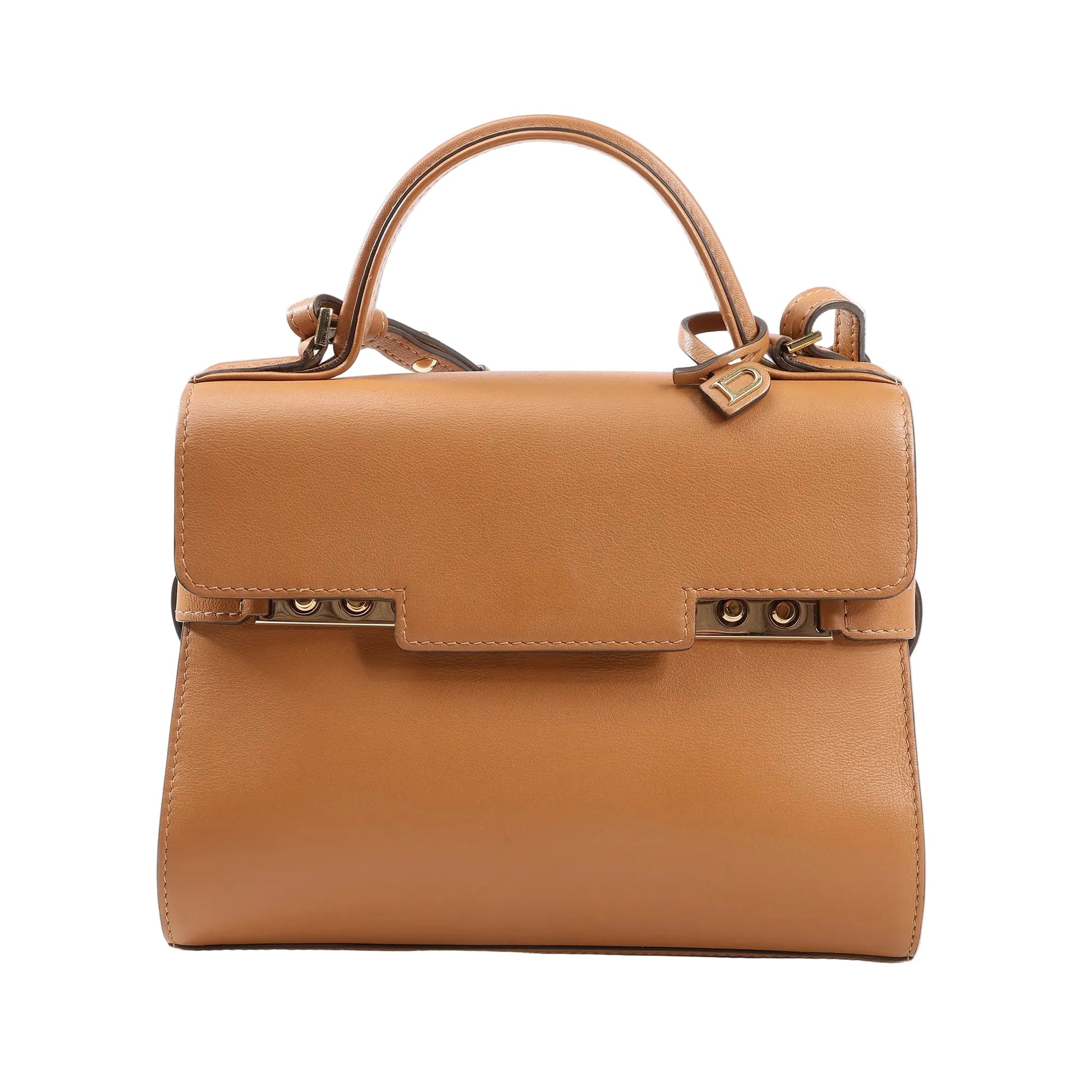 Delvaux Tempête PM handbag in smooth brown leather with top handle, adjustable shoulder strap, and gold-tone studded closure detail.
