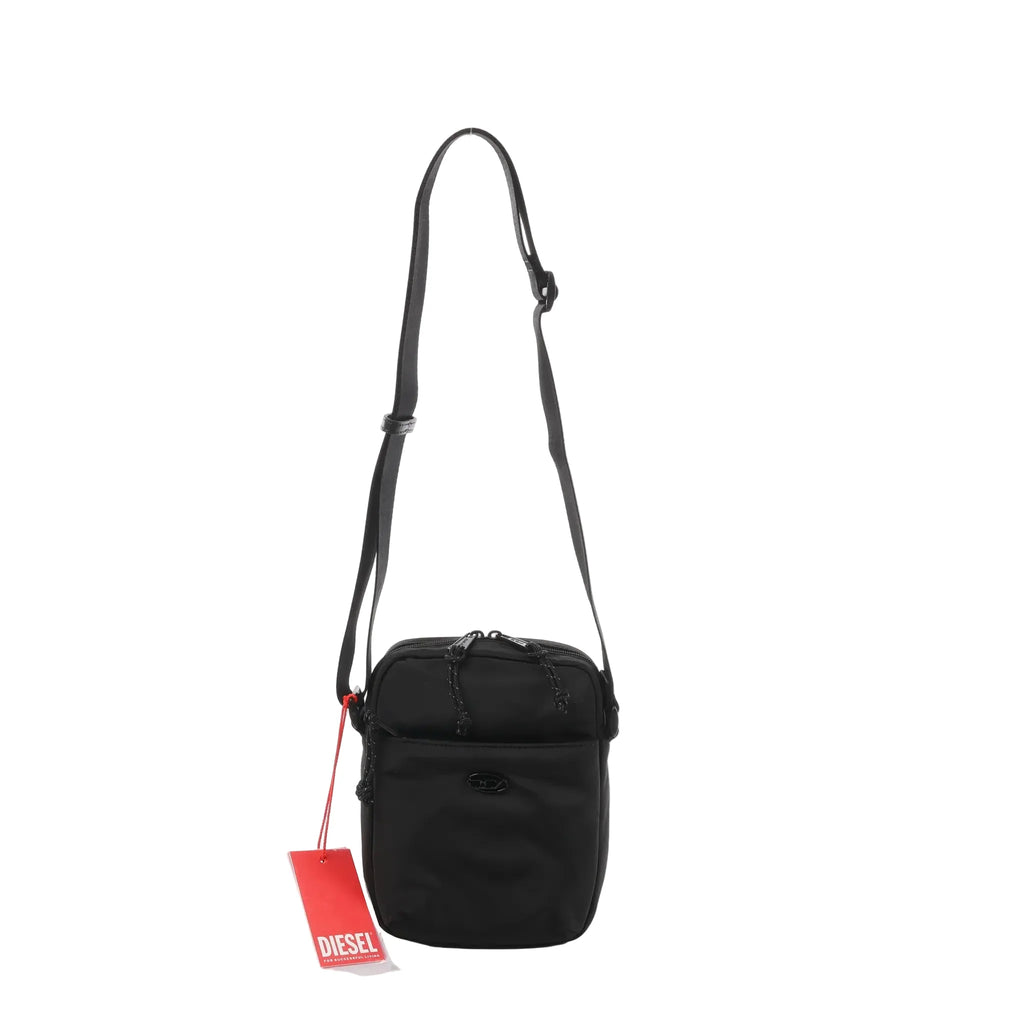 Black Diesel D-Pack nylon crossbody bag with adjustable shoulder strap, zip-top closure, front pocket, and red Diesel hangtag.
