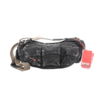Washed gray denim Diesel crossbody bag with multiple front pockets, zip-top closure, wide adjustable strap, and red Diesel hangtag.