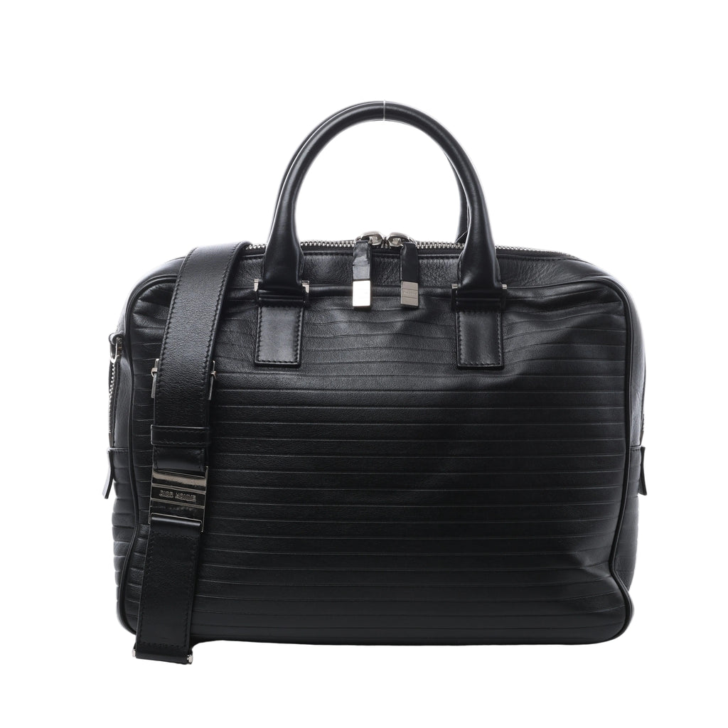 Black Dior Homme leather briefcase with horizontal stitched detailing, rounded top handles, wide shoulder strap and silver-tone zip hardware.