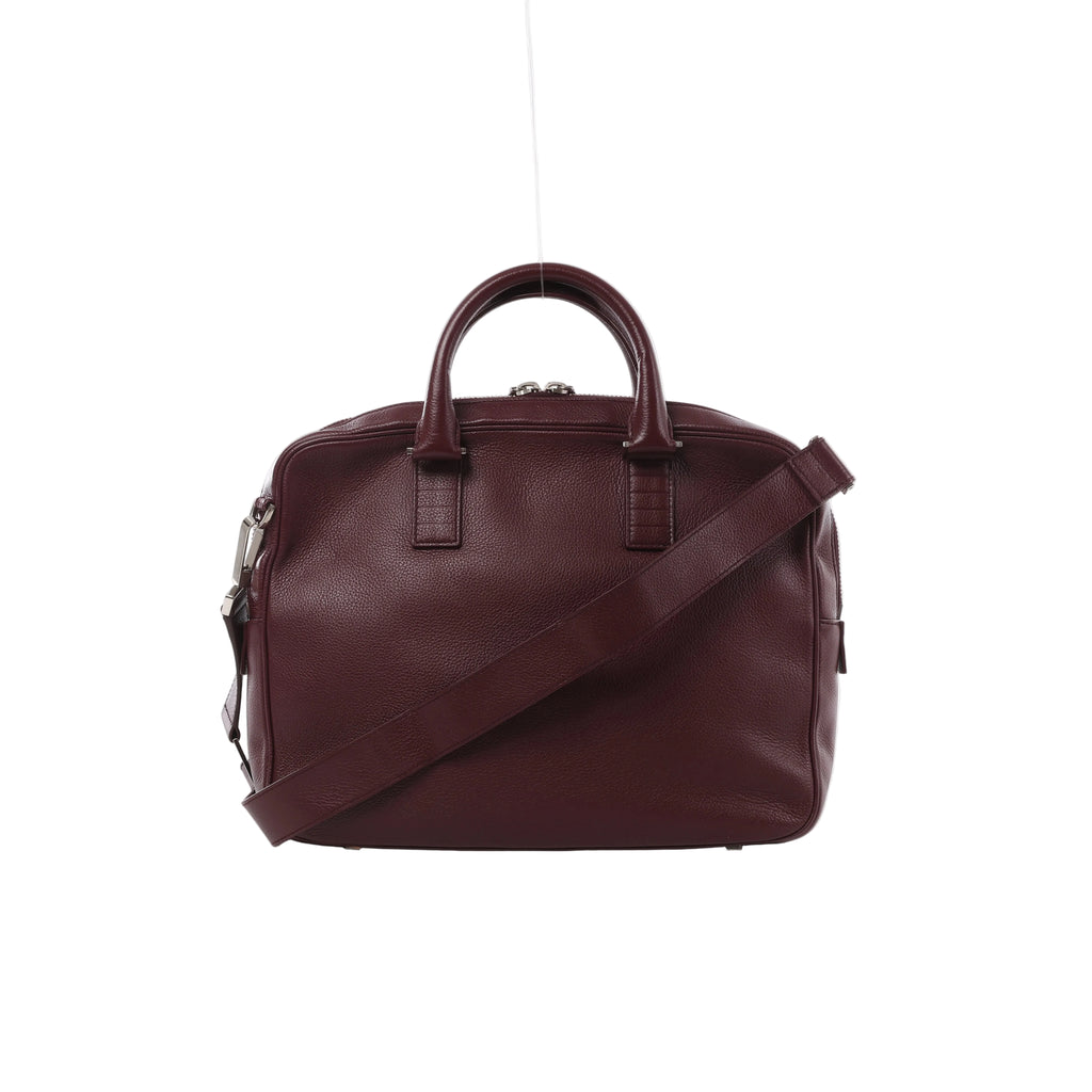 Burgundy Dior Homme leather business bag with rounded top handles, matching shoulder strap, zip closure and silver-tone hardware.