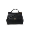 Black textured leather Dolce & Gabbana Sicily handbag with top handle, detachable shoulder strap, flap front and gold-tone logo plaque on white background.