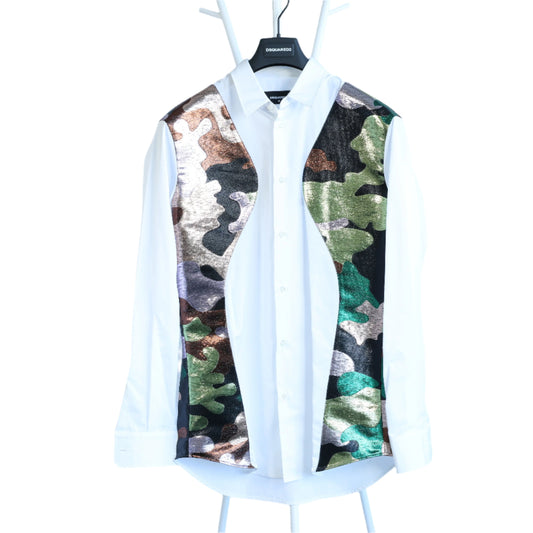 White shirt with camouflage vest on a hanger against a light blue background