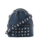 Navy blue Fendi leather bag with a rounded top, silver-tone geometric studs, a matching studded shoulder strap, top handle and front zip pocket.