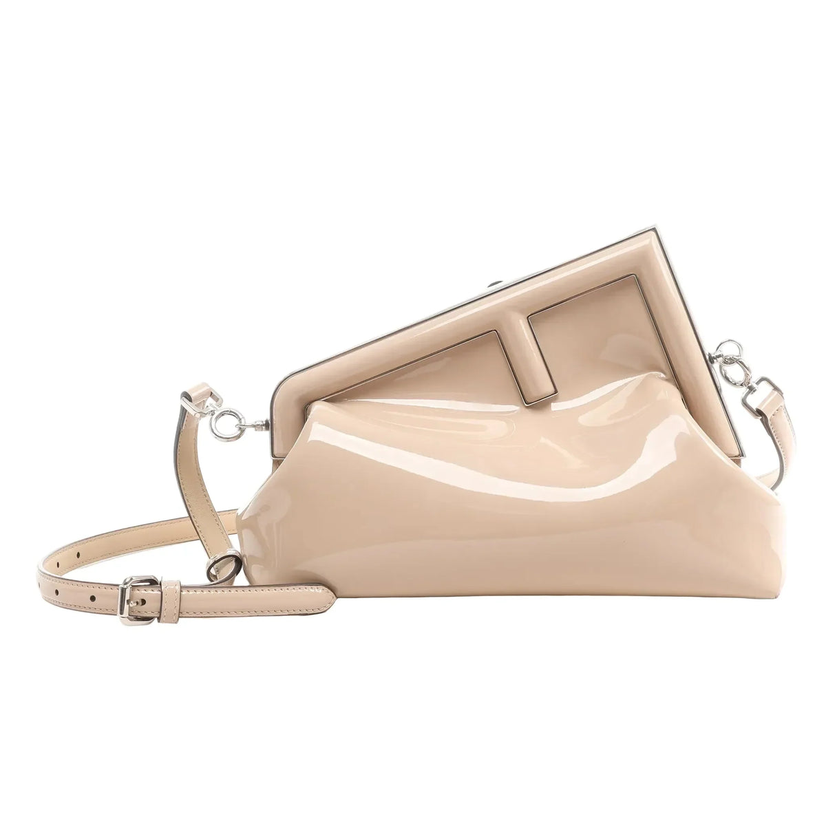 FENDI First crossbody bag in glossy beige patent leather with oversized F metal clasp, silver-tone hardware, and adjustable shoulder strap on a white background.