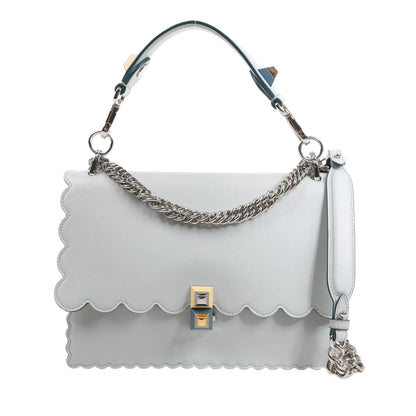 FENDI Kan I 2Way handbag in pastel blue leather with scalloped edges, silver-tone chain strap, detachable top handle, and gold-and-silver pyramid clasp, displayed against a white background.