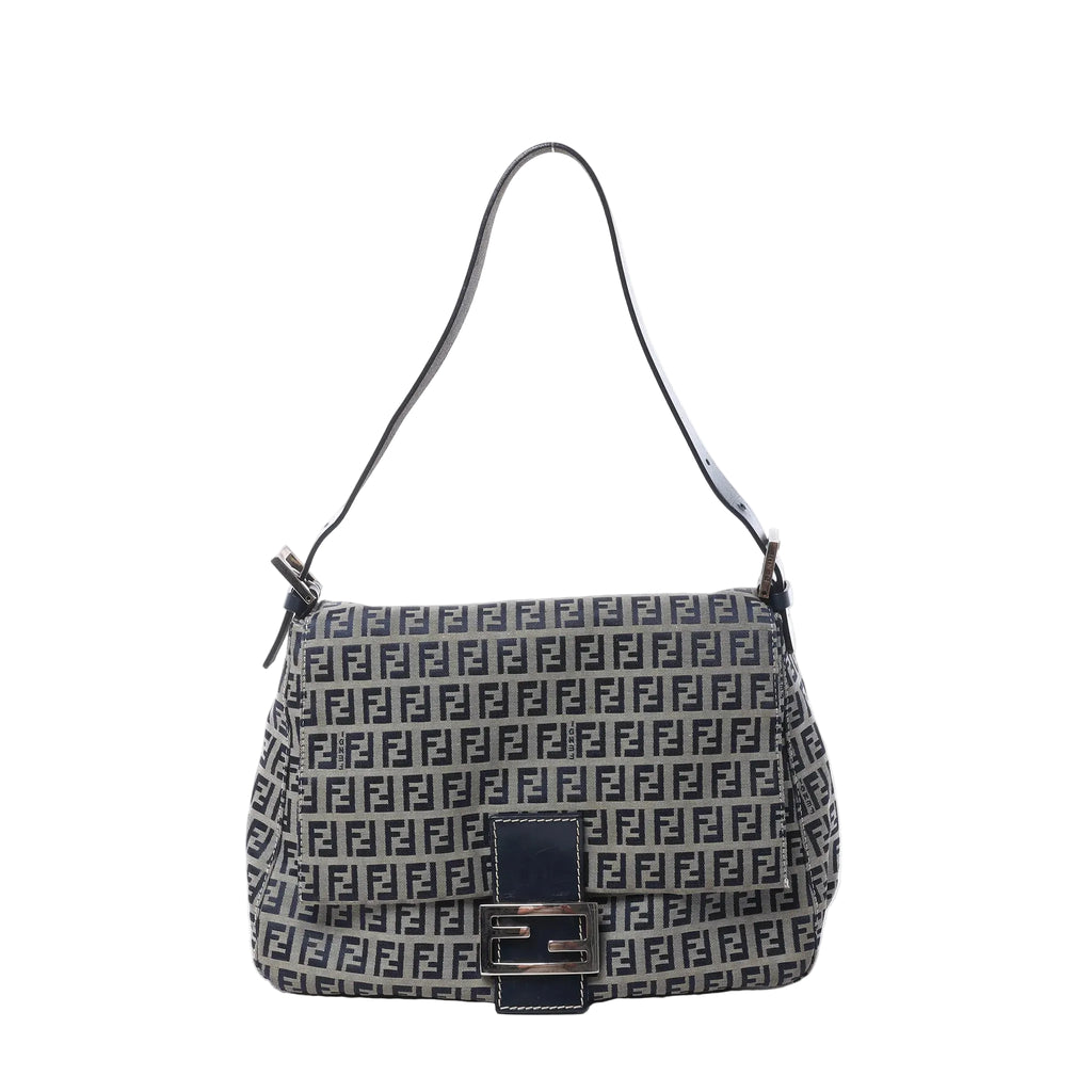 Fendi Mamma Baguette shoulder bag in navy blue and gray Zucchino canvas with black leather trim, slim shoulder strap, flap front, and silver-tone FF buckle on white background.