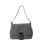 Fendi Mamma Baguette shoulder bag in navy blue and gray Zucchino canvas with black leather trim, slim shoulder strap, flap front, and silver-tone FF buckle on white background.