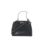 Black Fendi Peekaboo Mini leather handbag with top handle, detachable shoulder strap, and gold-tone twist-lock hardware, front view on a white background.